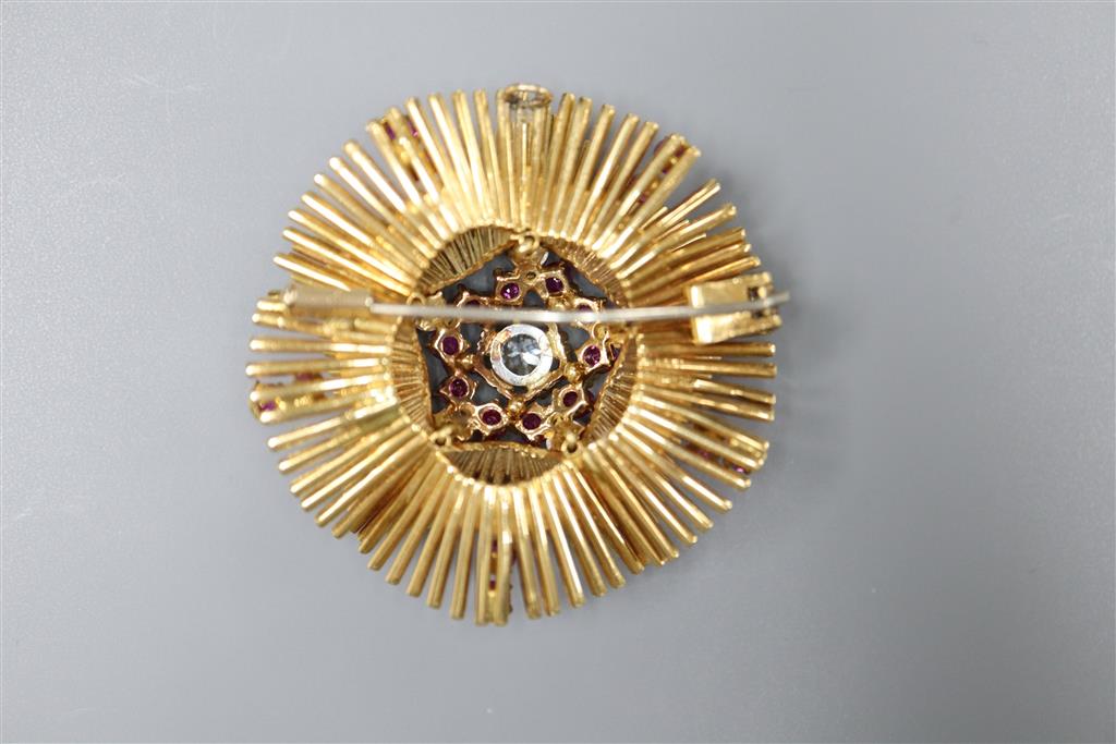 A late 1950s 18ct gold, ruby and diamond cluster set stylised flower head pendant brooch, 45mm, gross 39.3 grams.